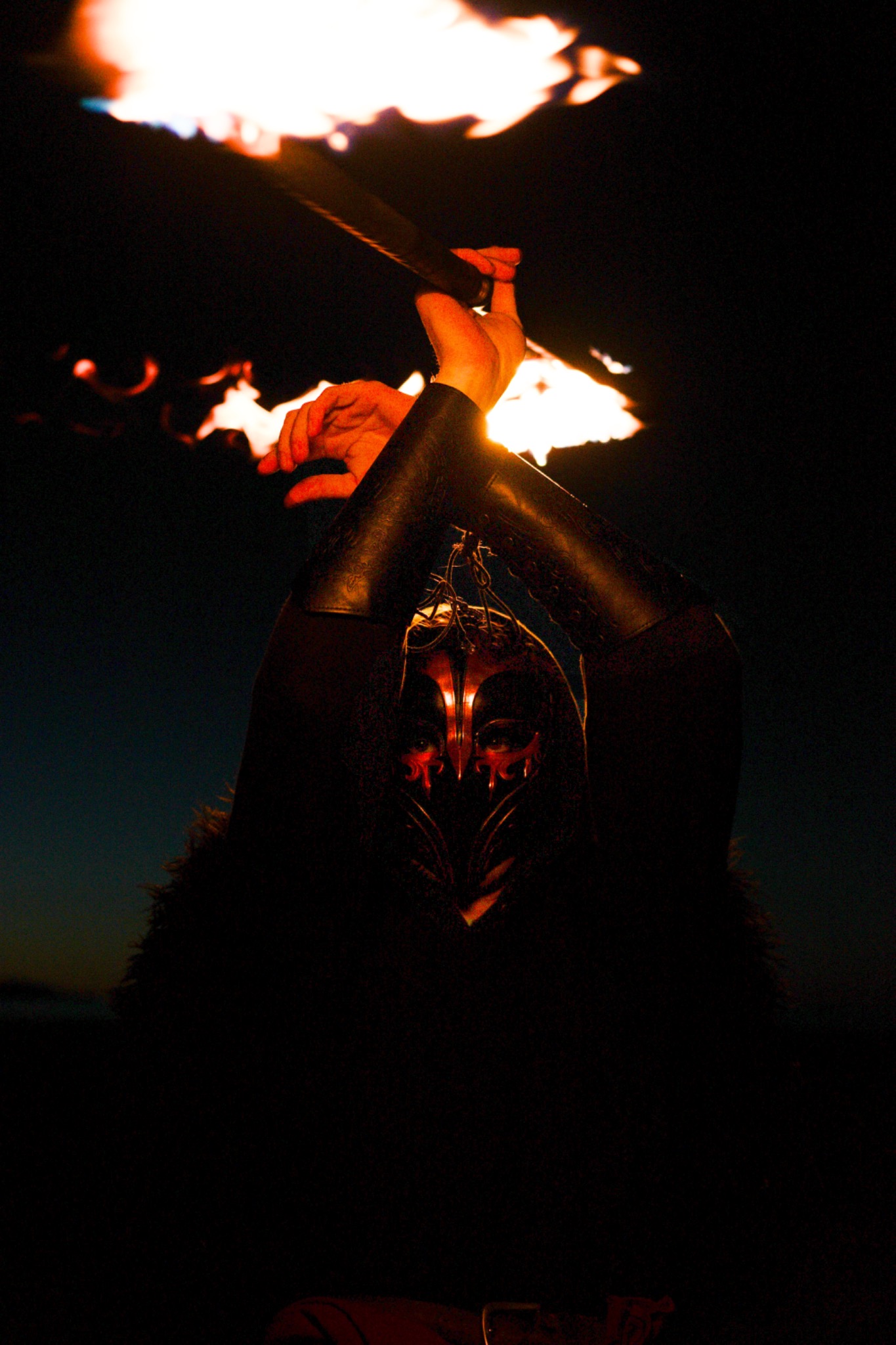 Masked performer with fire